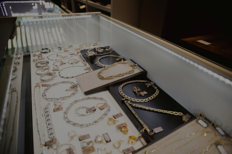 Beleuchtete Schmuckvitrine mit Gold- und Silberketten